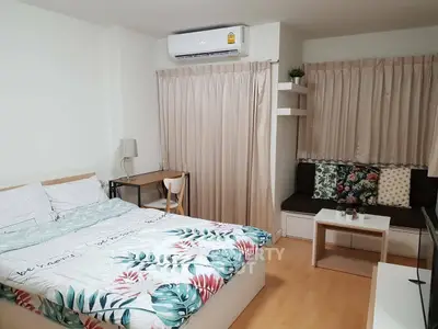 Cozy bedroom with modern decor and natural light, featuring a comfortable bed and stylish furnishings.