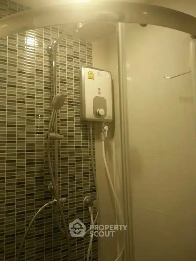 Modern bathroom shower with sleek design and electric water heater