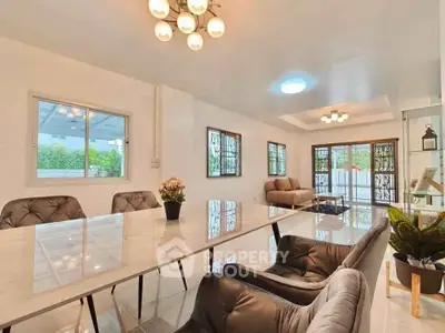 Spacious modern living room with elegant dining area and large windows.