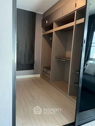 Spacious walk-in closet with modern design and ample storage space.