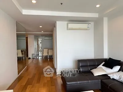 Modern living room with sleek leather sofa and wooden flooring