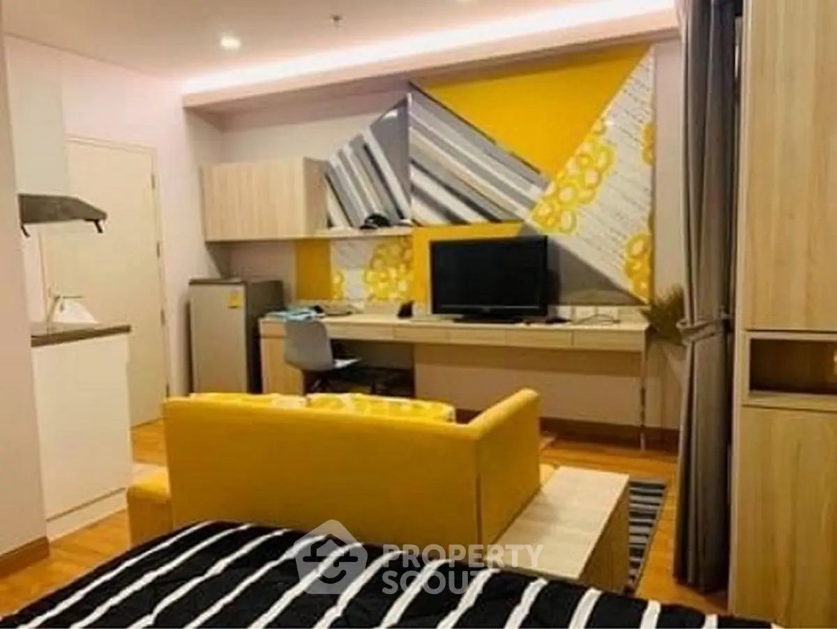 Modern studio apartment with vibrant yellow accents and stylish decor