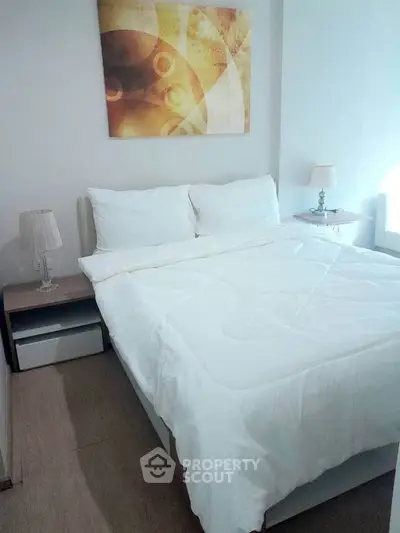 Cozy bedroom with modern decor and elegant lighting, perfect for relaxation and comfort.