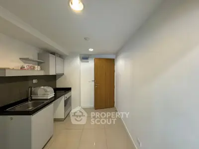 Modern compact kitchen with sleek cabinetry and minimalist design