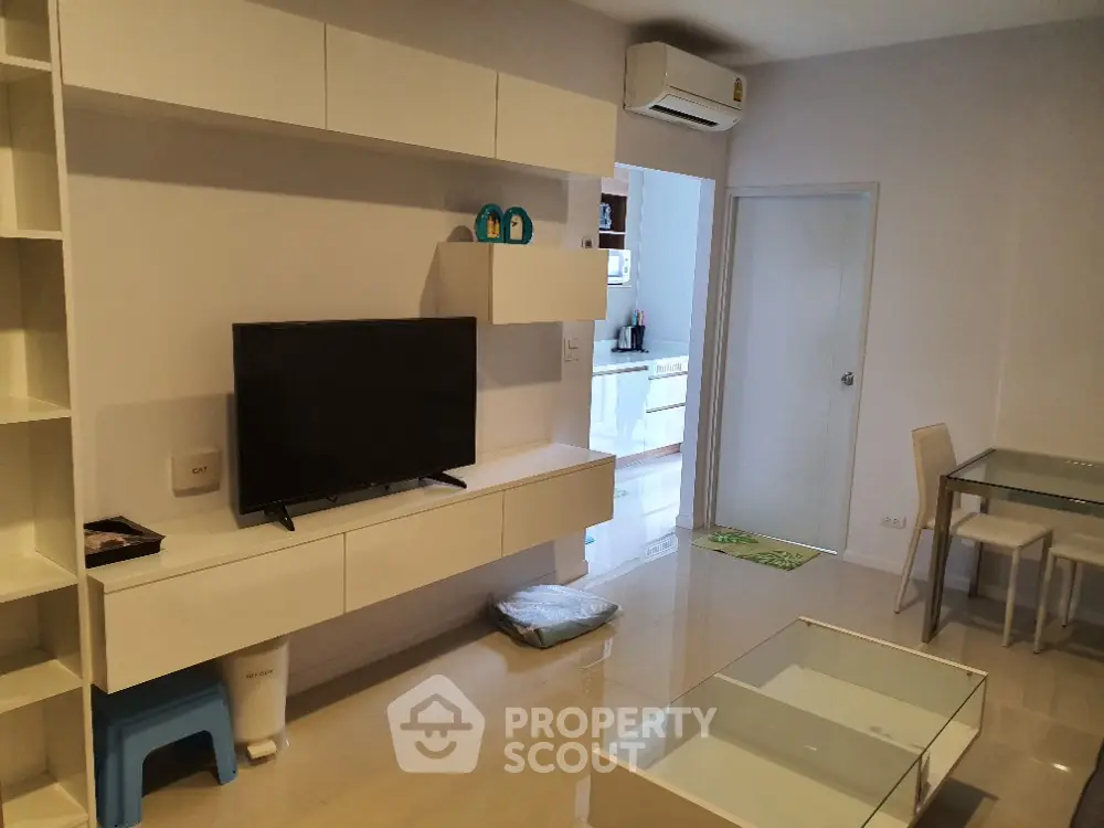 Modern living room with sleek furniture and open kitchen layout