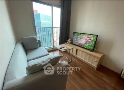 Modern living room with cozy sofa and large window offering city view