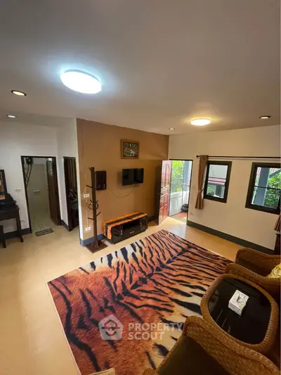 Spacious living room with tiger print rug and outdoor view
