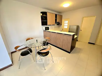 Modern kitchen with sleek cabinetry and dining area in open layout