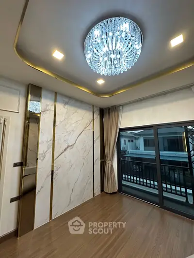 Luxurious living room with elegant chandelier and marble accent wall
