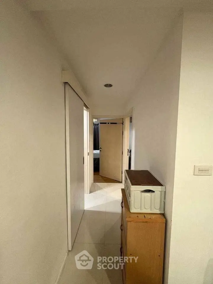 Spacious hallway with modern sliding doors and ample storage space.