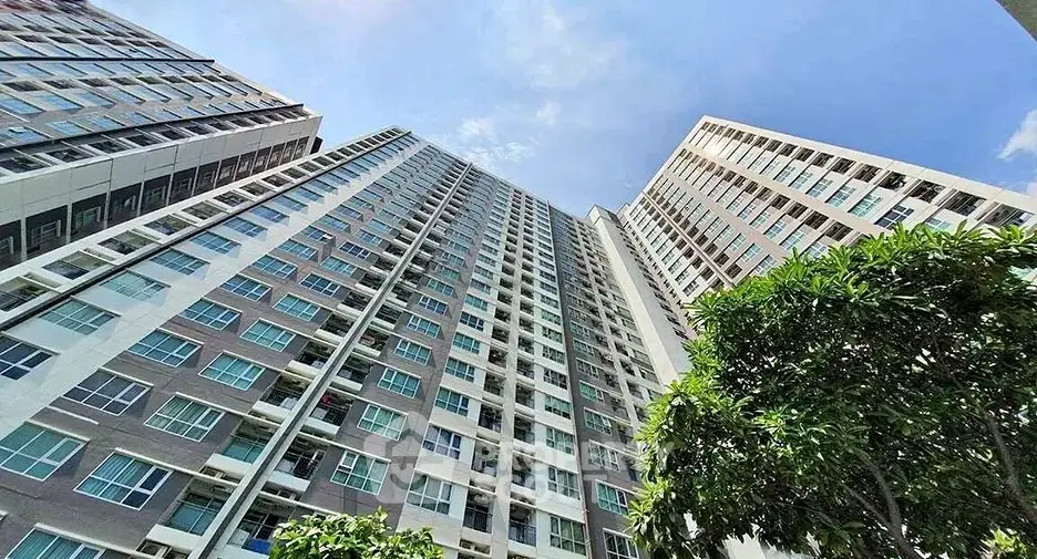 Stunning high-rise building exterior with modern architecture and lush greenery.