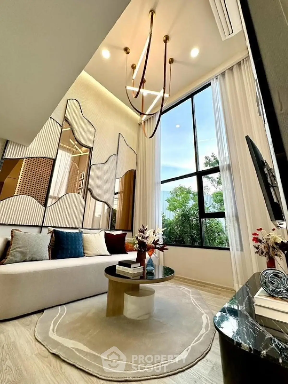 Luxurious modern living room with high ceilings and elegant chandelier