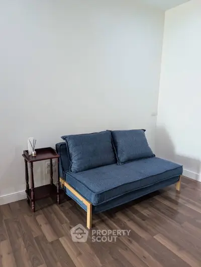 Modern living room with stylish gray sofa and wooden flooring