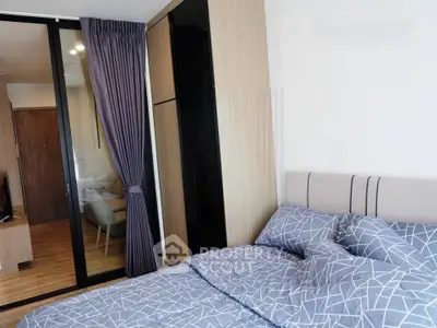 Modern bedroom with stylish decor and sliding glass doors leading to a cozy living area.