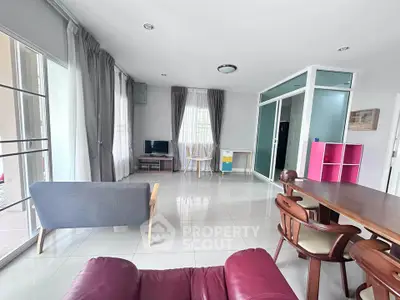 Spacious living room with modern furniture and large windows for natural light.