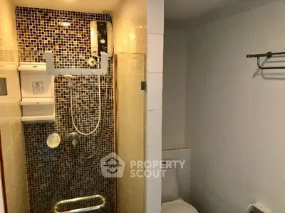 Modern bathroom with mosaic tile shower and sleek fixtures