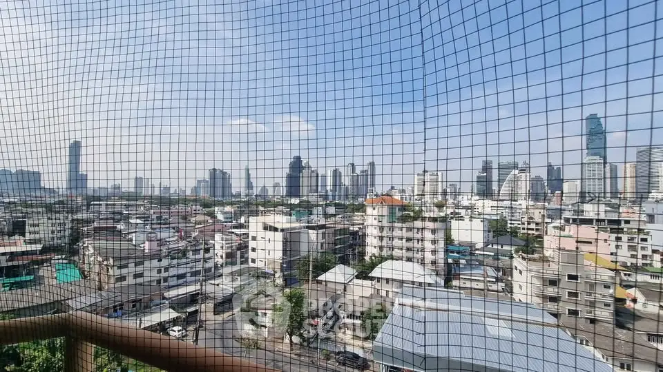 Stunning cityscape view from a high-rise balcony with protective netting