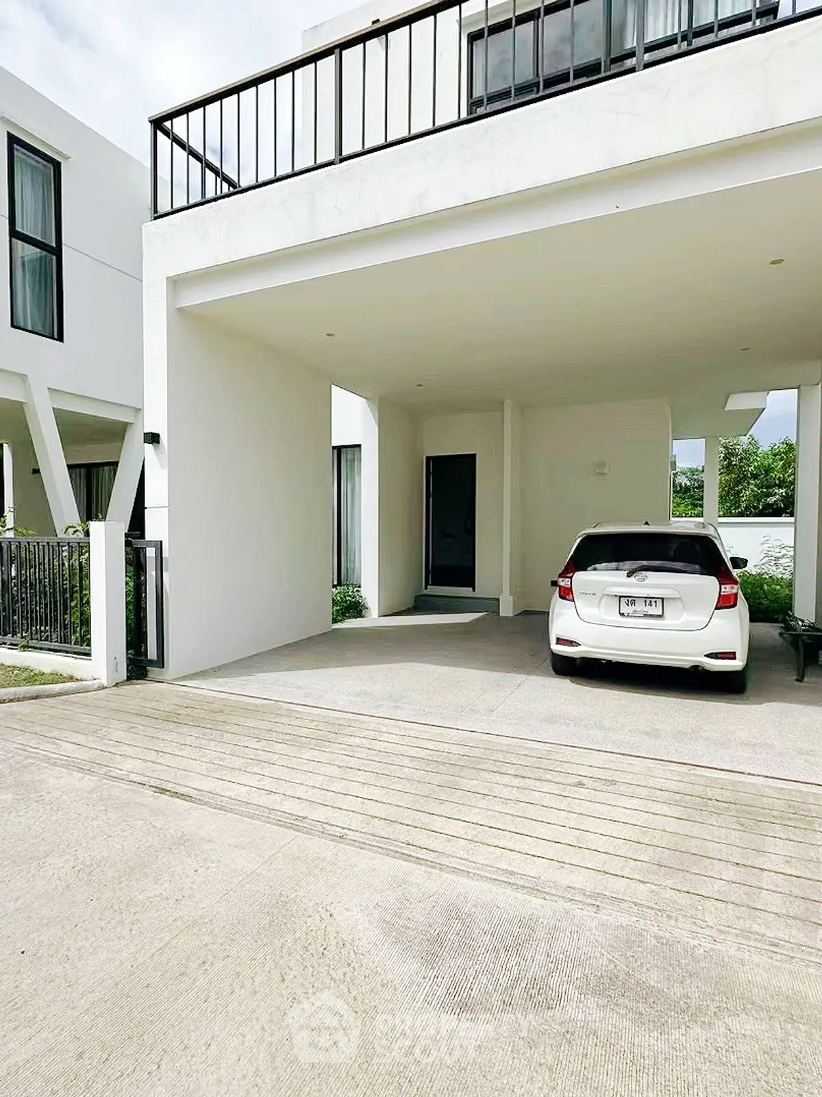 Modern white house with covered parking and sleek design