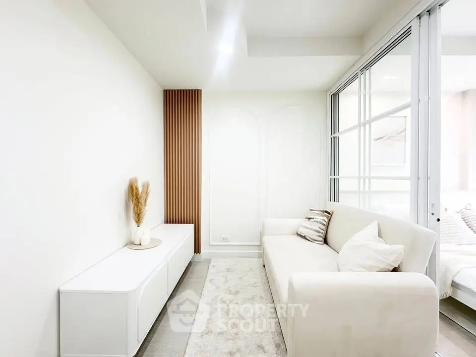 Bright and modern living room with sleek white furniture and elegant decor