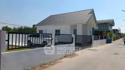 Charming single-story house with modern design and spacious driveway in a serene neighborhood.