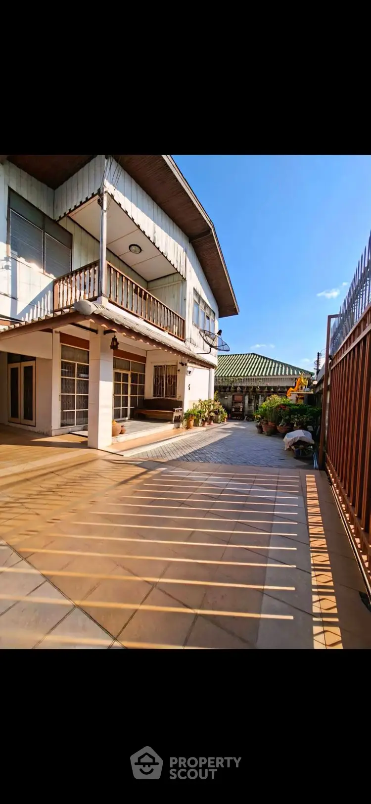 Spacious two-story house with large driveway and sunny courtyard