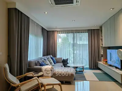 Modern living room with cozy sectional sofa and large windows for natural light.