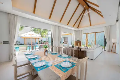Luxurious open-plan living and dining area with pool view, high ceilings, and elegant decor.