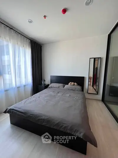 Modern bedroom with sleek design and ample natural light