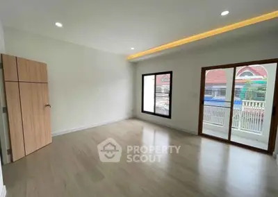 Spacious empty room with large windows and balcony access, perfect for customization.
