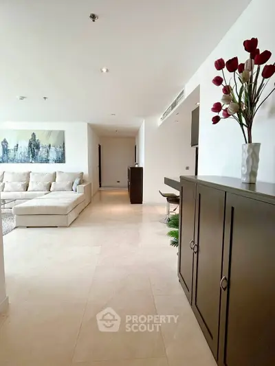 Spacious modern living room with elegant decor and comfortable seating in a luxury apartment.