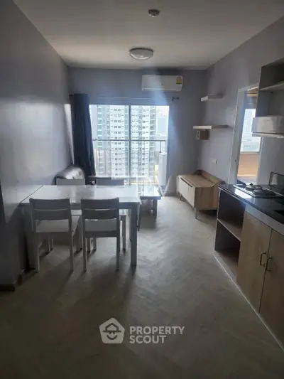 Modern apartment interior with dining area and city view, featuring sleek furniture and natural light.