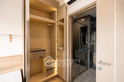 Modern bedroom with built-in closet and ensuite bathroom in luxury apartment