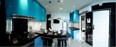 Modern kitchen with blue LED lighting, sleek black countertops, and high-end appliances, perfect for culinary enthusiasts.