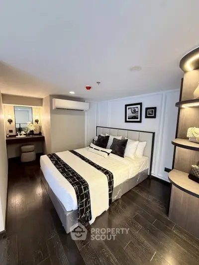 Luxurious modern bedroom with elegant decor and dark wood flooring