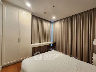 Cozy bedroom with elegant curtains and built-in wardrobe, perfect for restful nights.