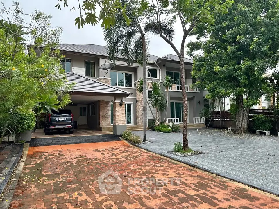 Spacious two-story home with lush greenery and ample parking space