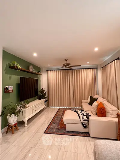 Charming living room with elegant decor, cozy seating, and stylish entertainment center.