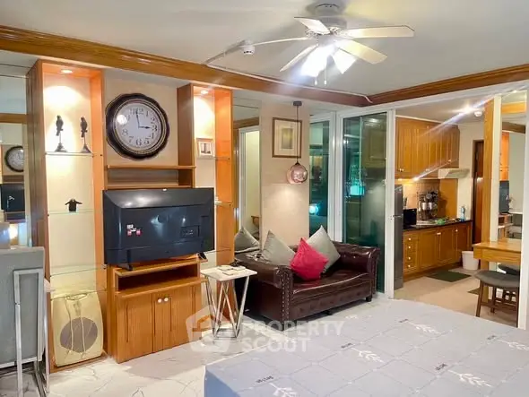 Spacious living room with modern decor and open kitchen layout, featuring stylish furniture and ample lighting.