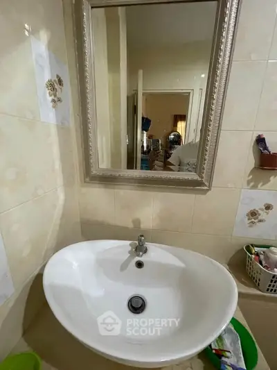 Cozy bathroom with elegant mirror and modern sink in a stylish home.