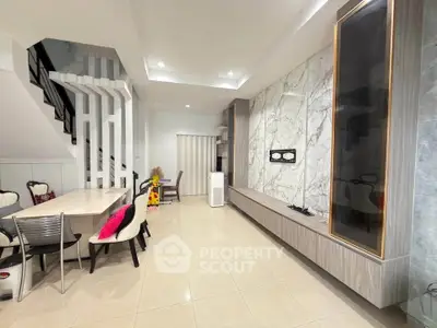 Modern living room with elegant marble wall and stylish dining area