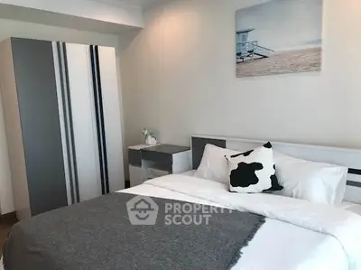 Modern bedroom with stylish decor and cozy ambiance, featuring a comfortable bed and sleek wardrobe.