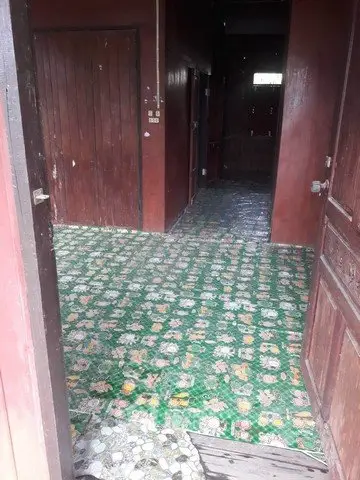 Charming vintage interior with colorful patterned tile flooring and wooden walls.