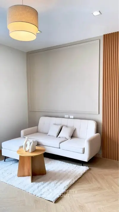 Modern living room with stylish sofa and wooden accents, perfect for cozy relaxation.