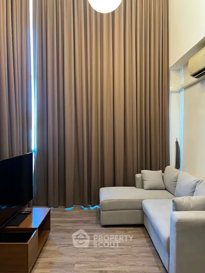 Modern living room with high ceilings and elegant curtains