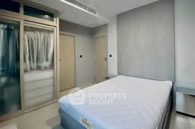 Modern minimalist bedroom with sleek wardrobe and comfortable bed