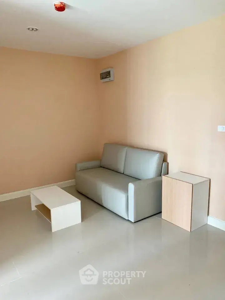 Minimalist living room with modern sofa and coffee table in a cozy apartment.