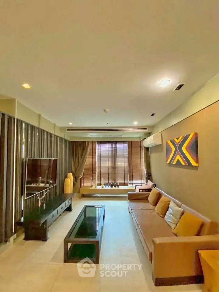 Spacious modern living room with stylish decor and large windows