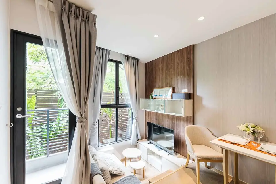 Chic modern living room with large windows and elegant decor, perfect for urban living.