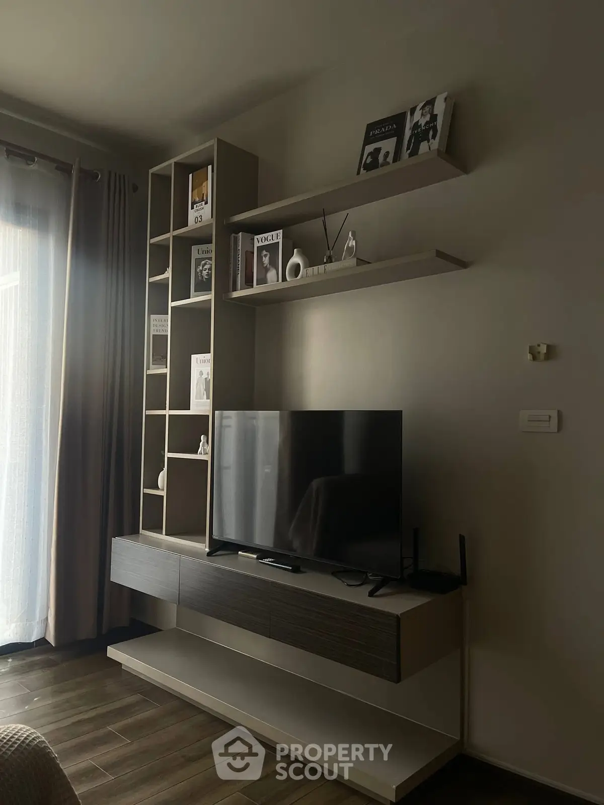 Modern living room with sleek TV unit and stylish shelving, perfect for contemporary living.