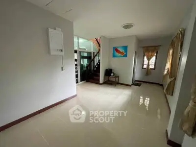 Spacious living room with modern decor and natural light, perfect for family gatherings.